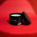 Candle in a black container labeled 'Sunshine' on a red background